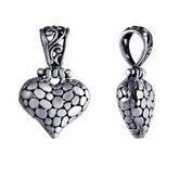 Handcrafted sterling silver heart pendant with textured detailing and ornate Balinese design, a timeless symbol of love and artisan jewelry for women.